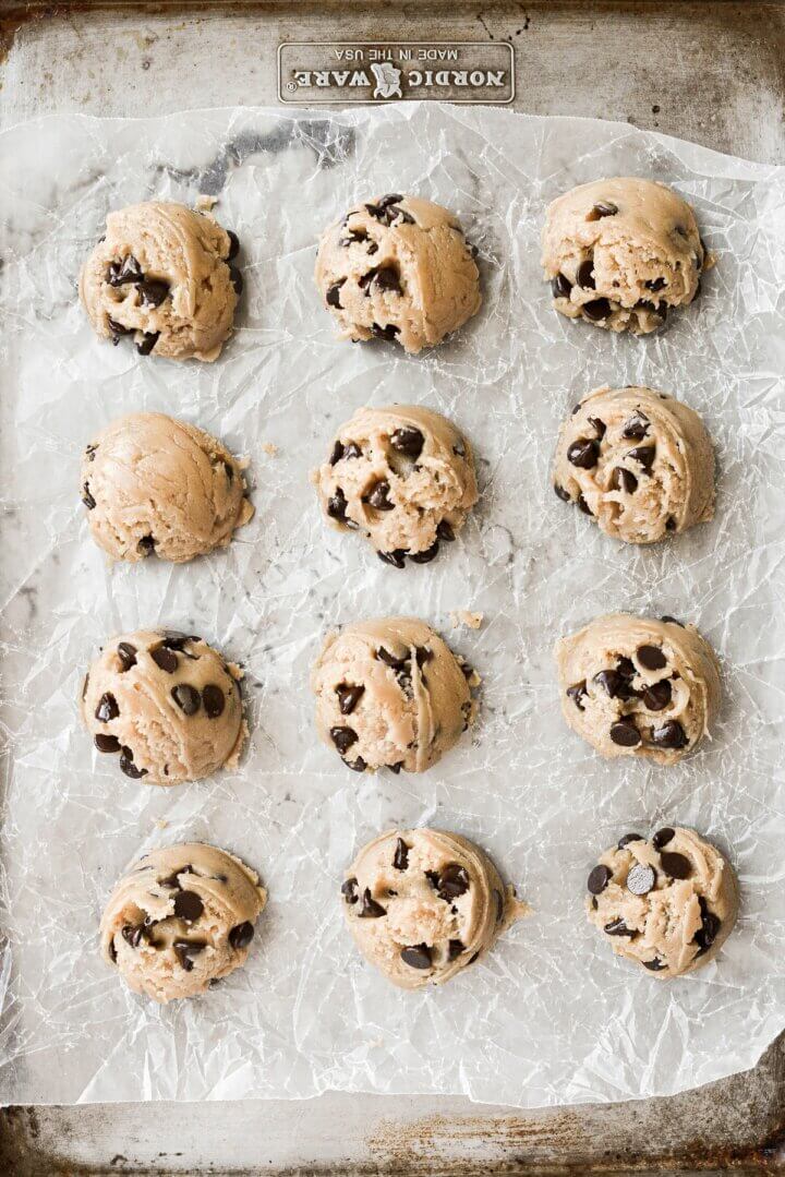 Chocolate chip cookie dough scooped into balls.