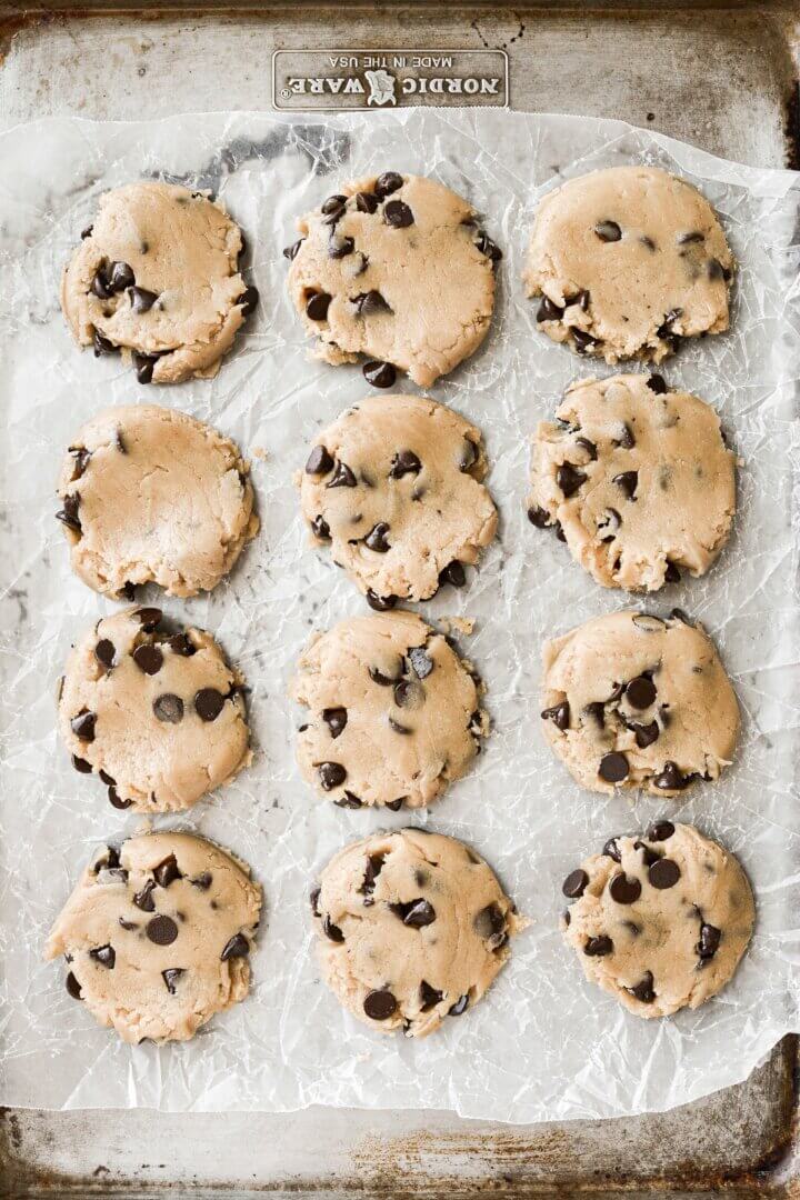 Chocolate chip cookie dough on a baking sheet.