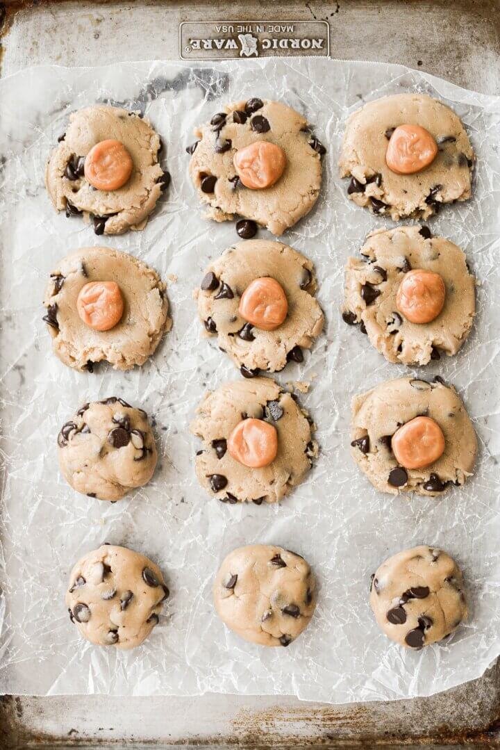 Chocolate chip cookie dough topped with pieces of soft caramels.