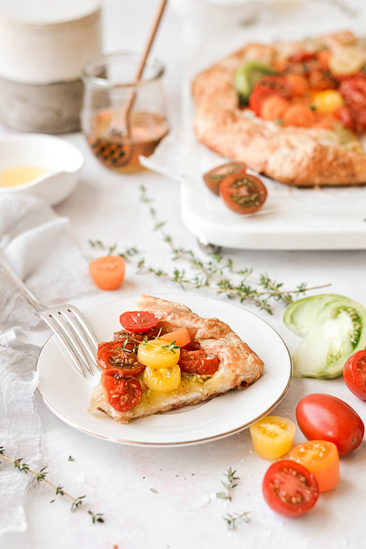 A slice of tomato galette on a white plate.
