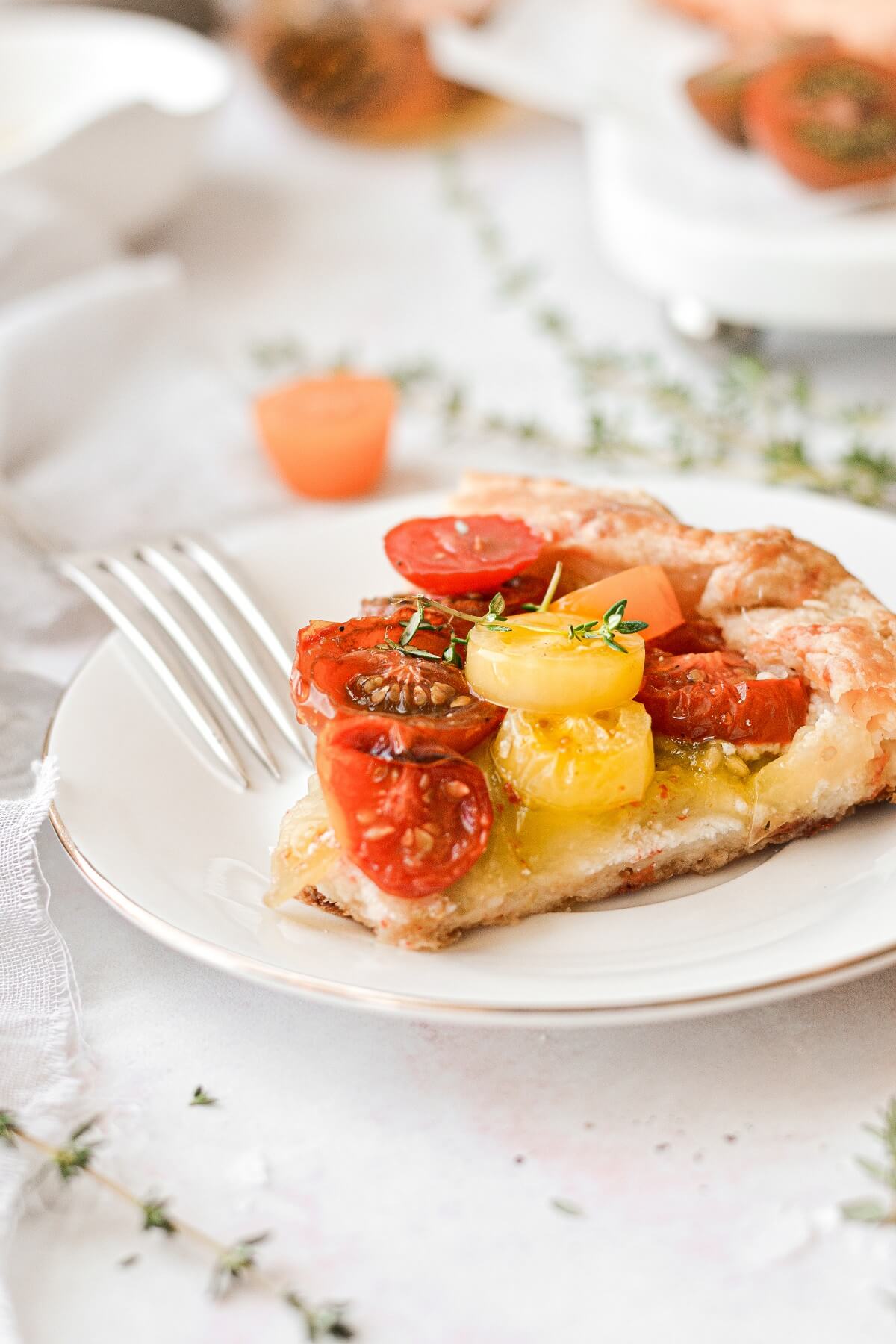 A slice of tomato galette on a white plate.