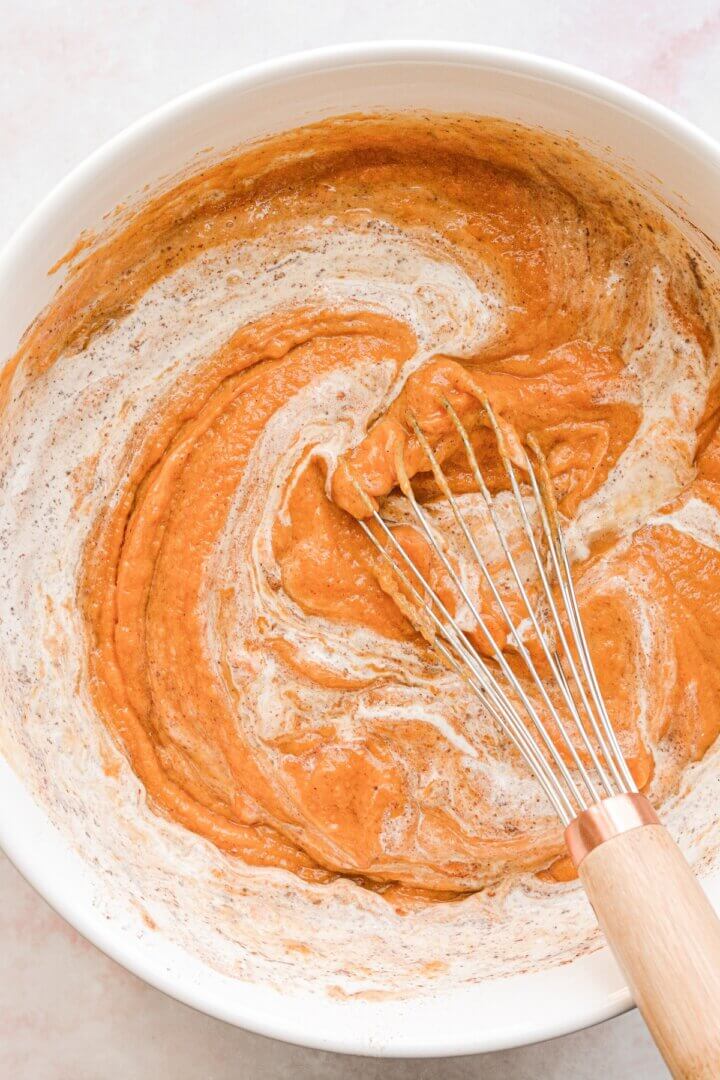 Sweet potato casserole filling, whisked together in a bowl.