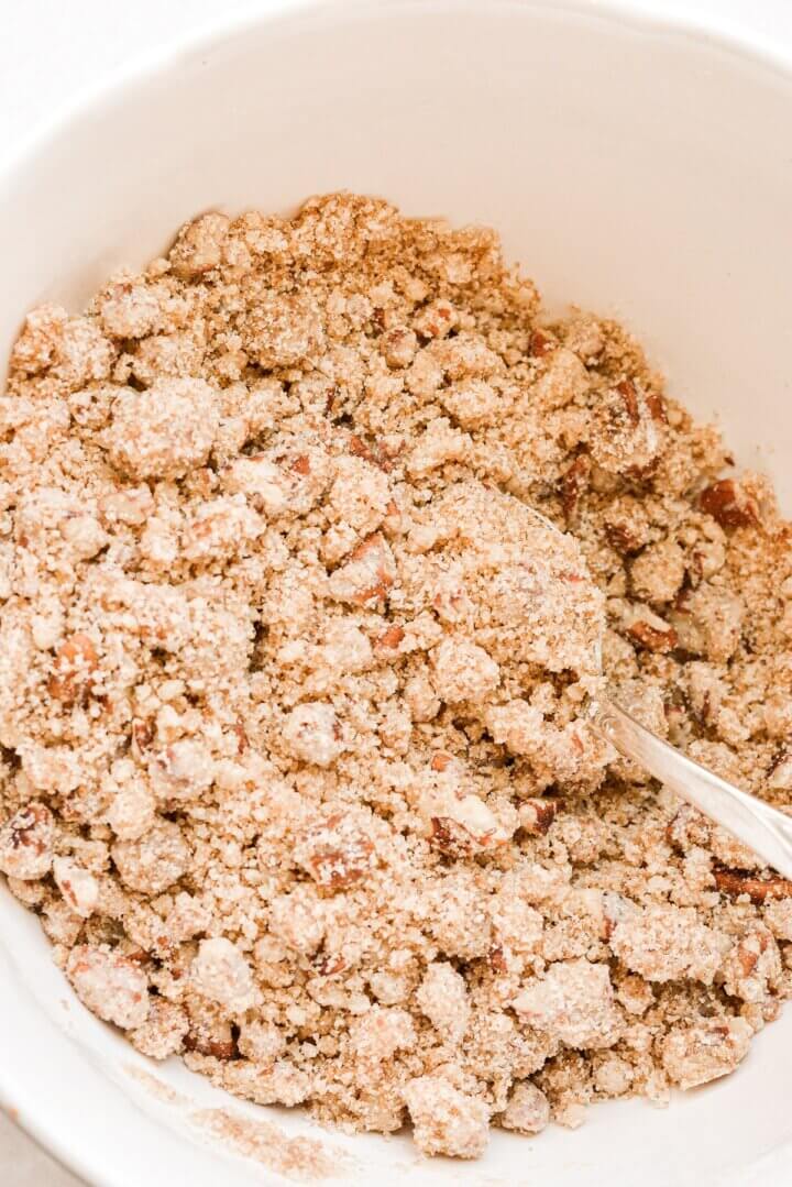 A bowl of crumb topping for sweet potato casserole.