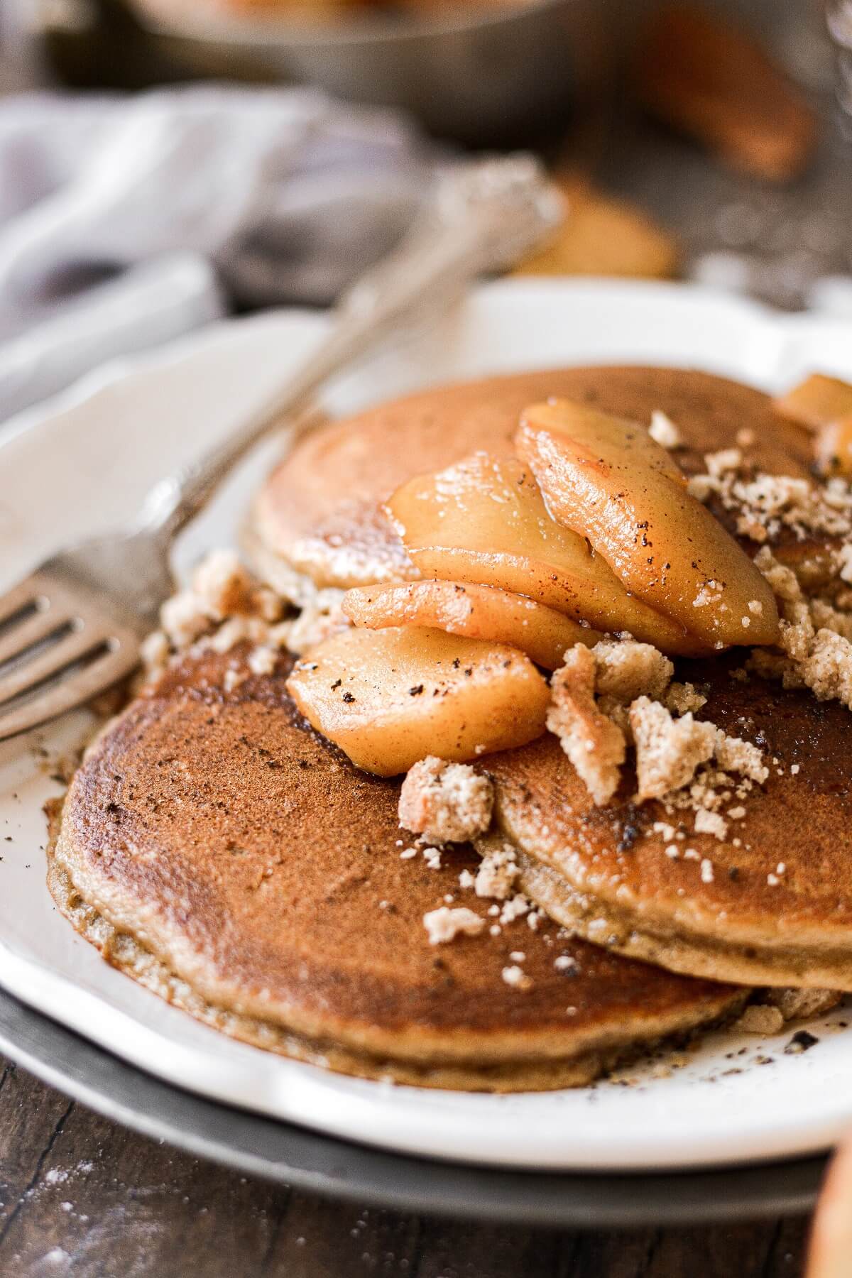Apple cider pancakes topped with cinnamon apples.