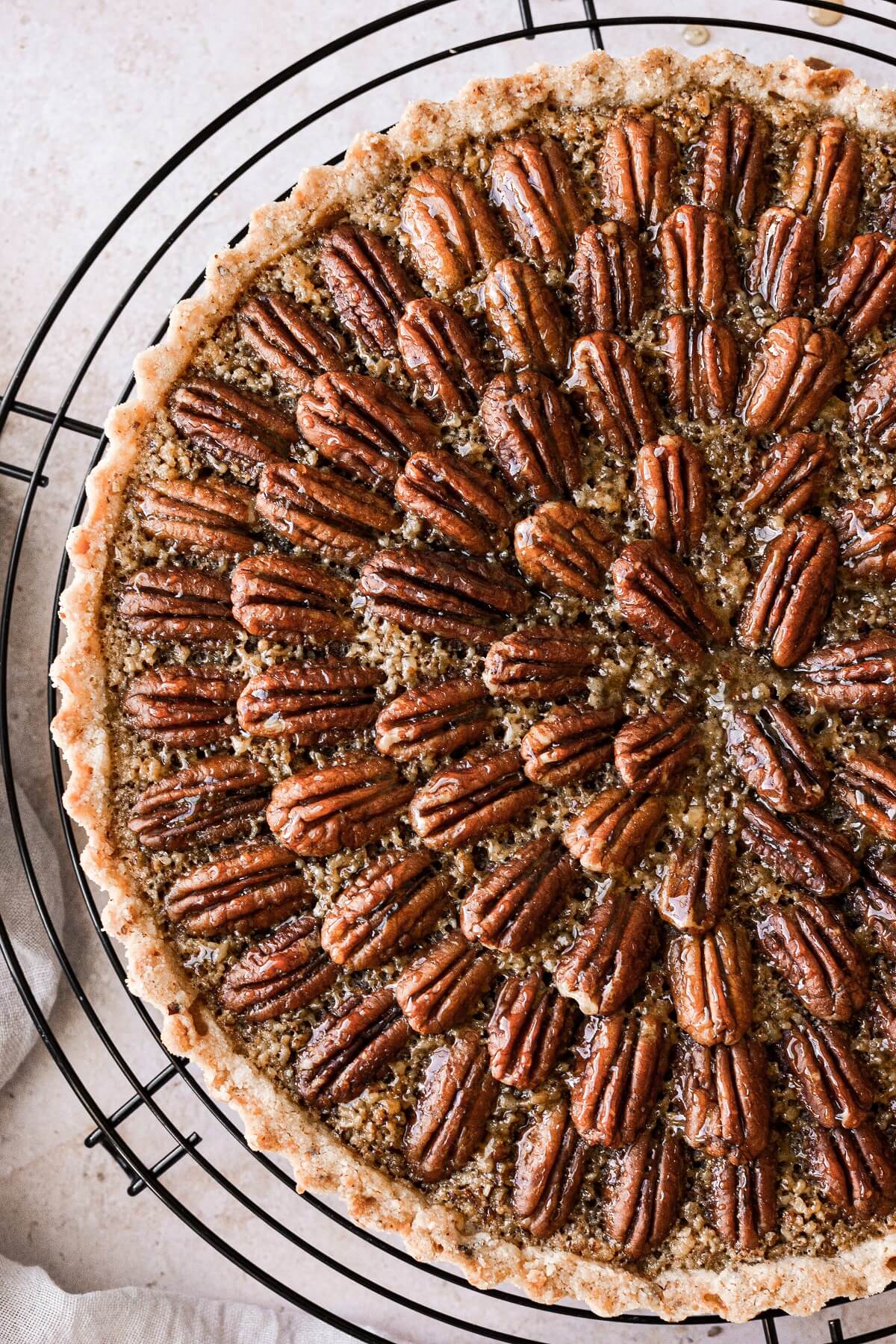 Closeup of a maple pecan tart decorated with pecans.