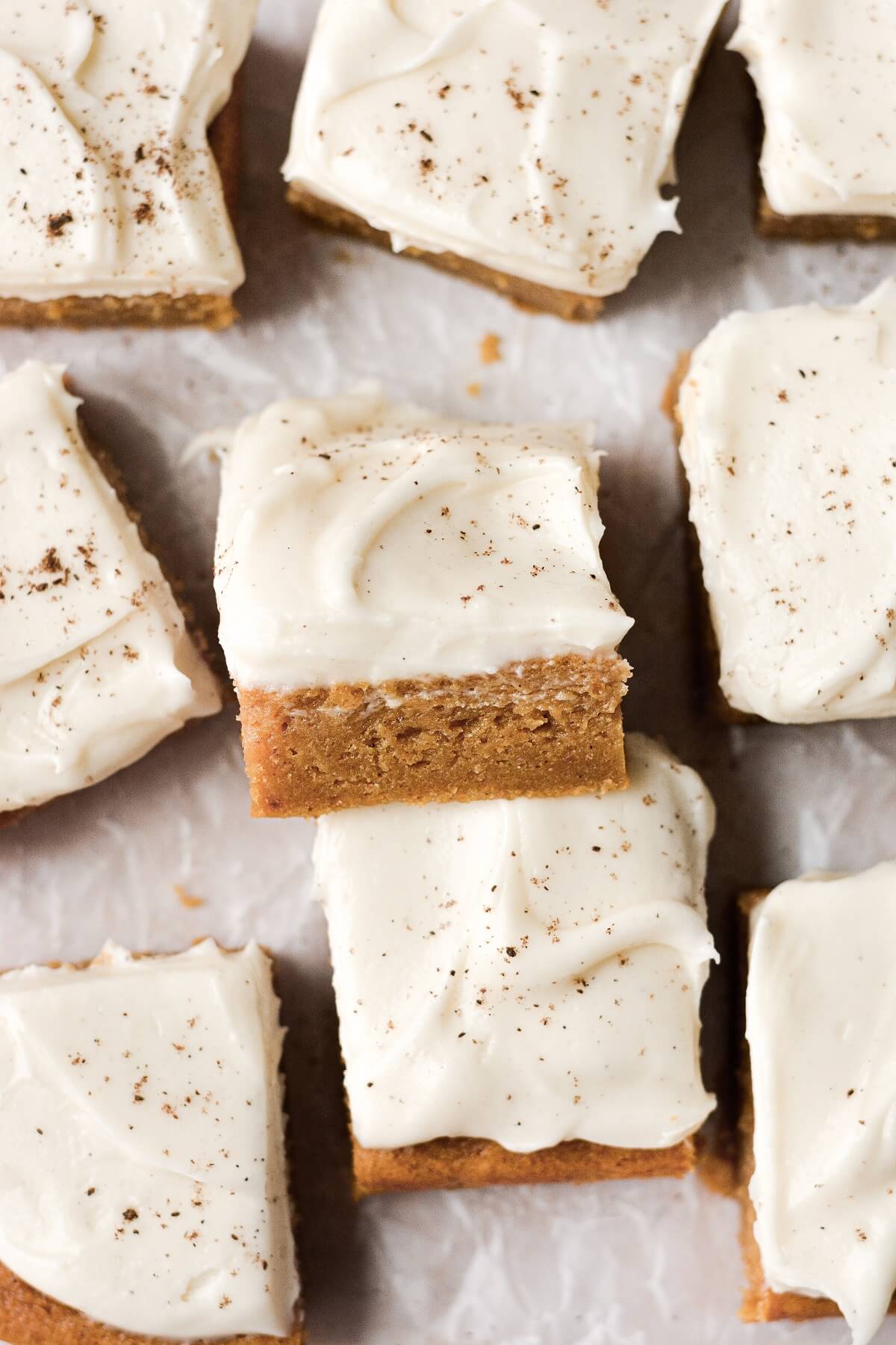 Pumpkin bars with cream cheese frosting cut into squares.