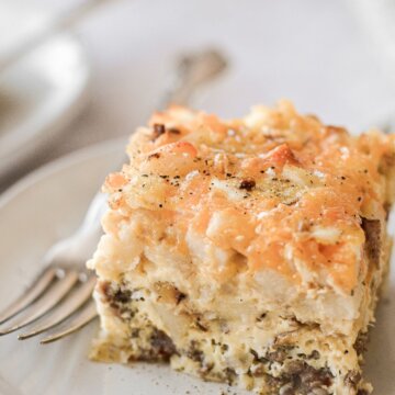 A piece of sausage hashbrown breakfast casserole on a plate.