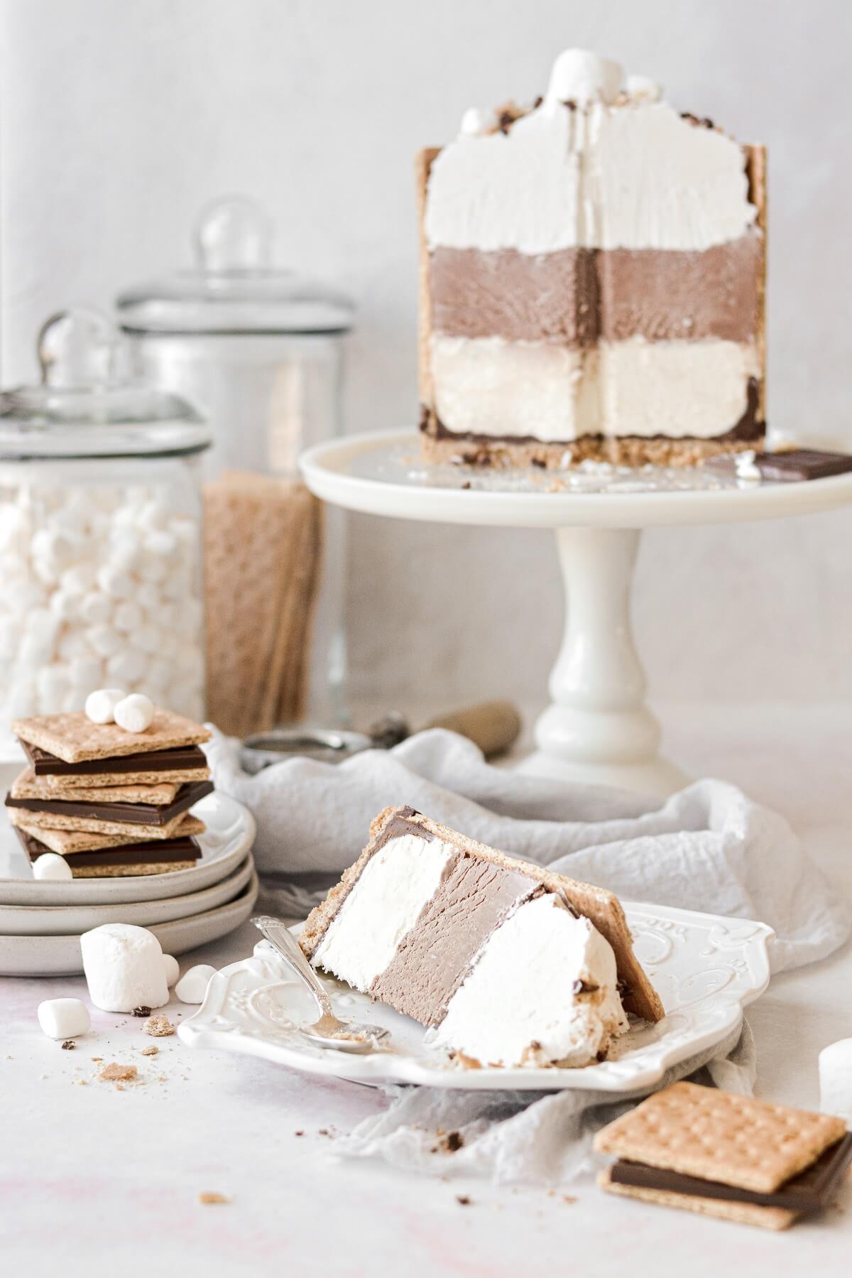 A s'mores ice cream cake with one slice on a plate.