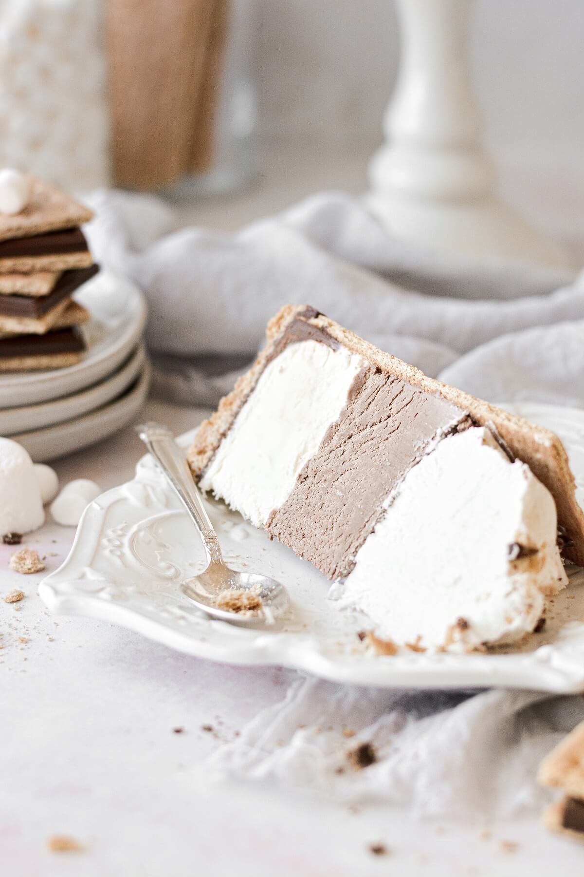 A slice of s'mores ice cream cake on a white plate.
