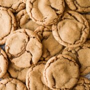 Soft ginger molasses cookies arranged on a baking sheet.