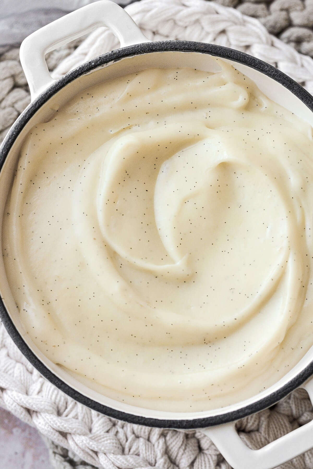 Closeup of vanilla bean specks in homemade custard.