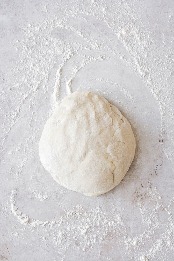 Dough ready to be rolled out on a floured surface.