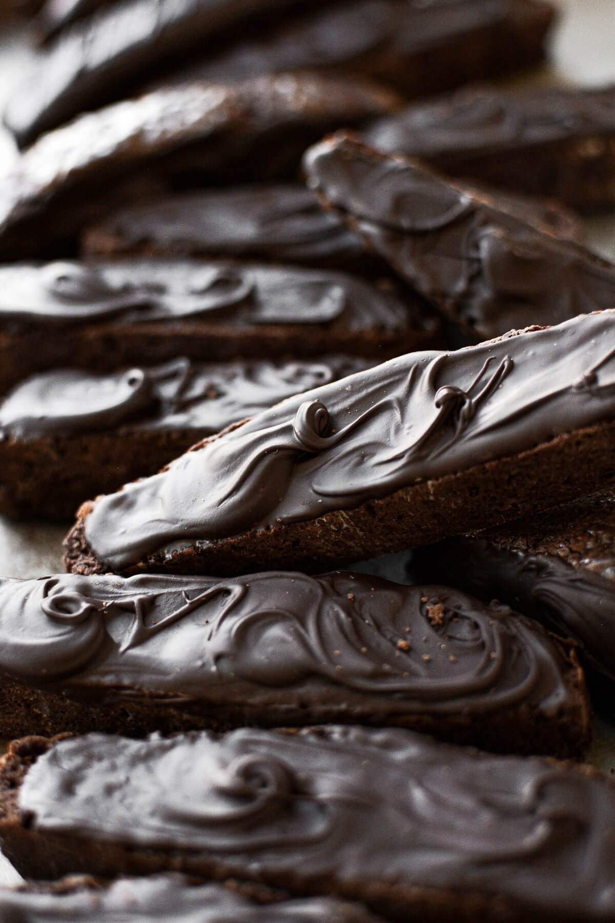 Closeup of chocolate biscotti spread with swirls of melted chocolate.