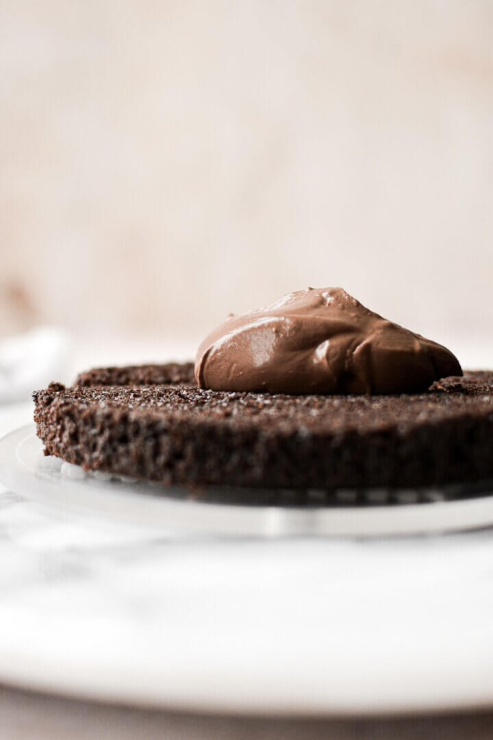 Custard spread onto a layer of chocolate cake.