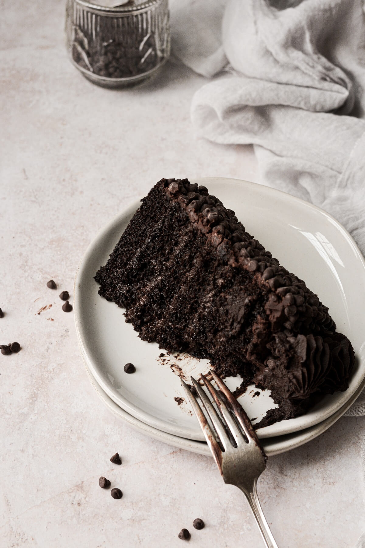 A slice of chocolate truffle cake with a bite taken.
