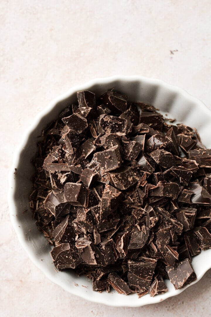 Chopped chocolate in a fluted ramekin.