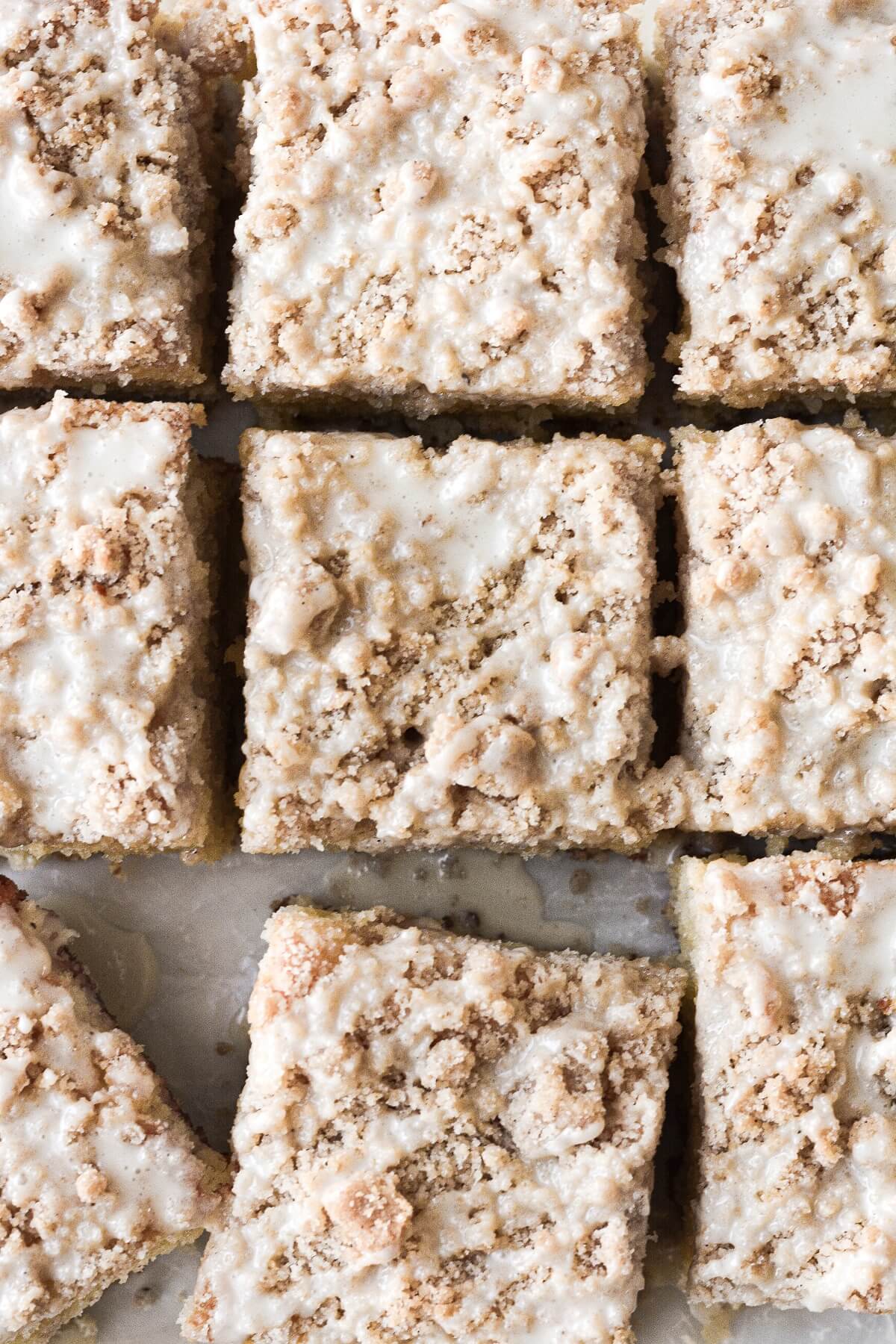 Squares of eggnog coffee cake drizzled with icing.