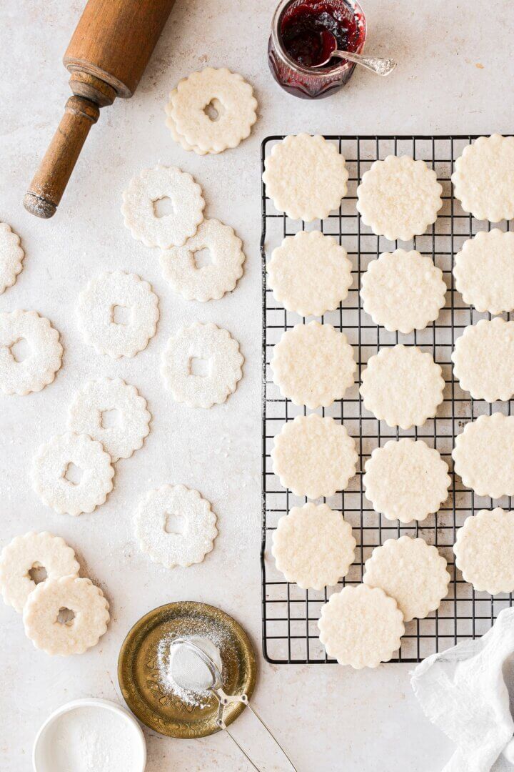 Linzer cookies dusted with powdered sugar, ready to be filled with cherry jam.