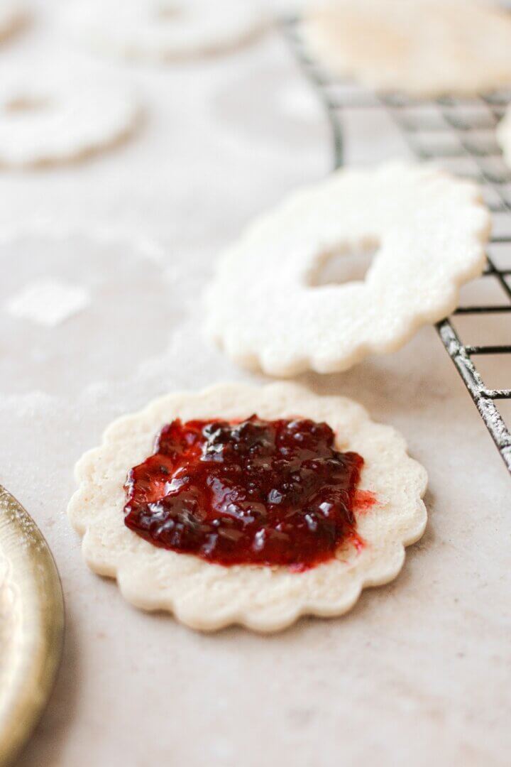 A shortbread cookie topped with cherry jam.