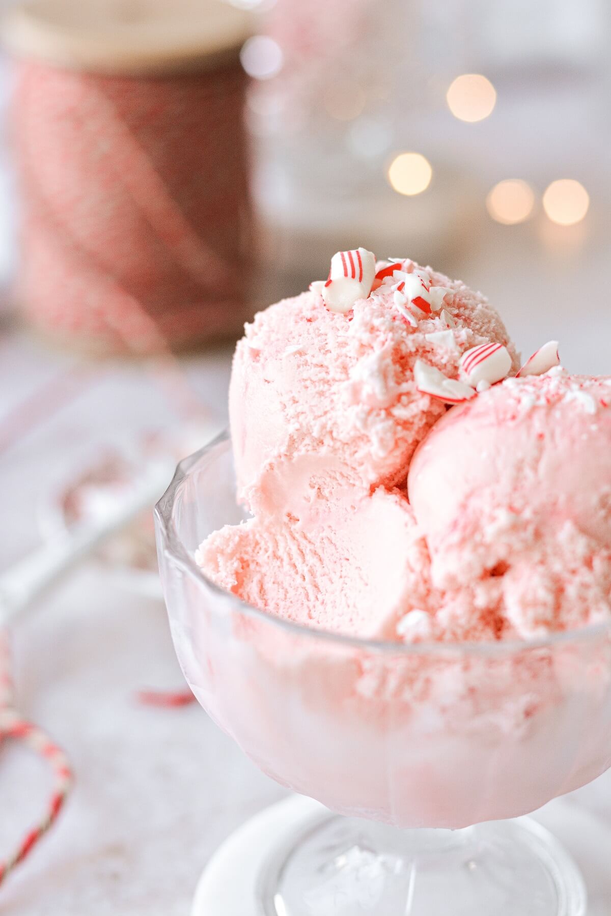A glass dish of peppermint ice cream with a bite taken.