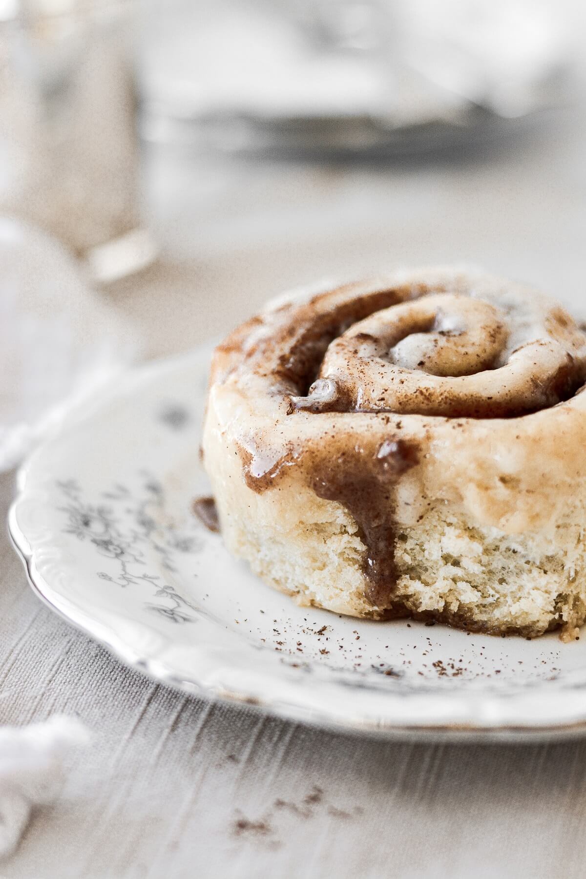 A cinnamon roll dripping with icing.