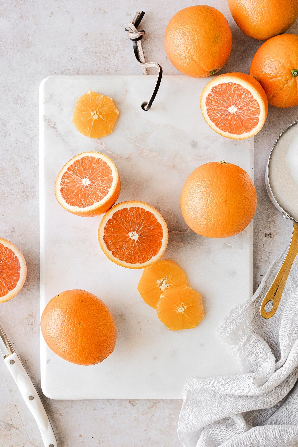 Cut oranges on a marble cutting board.