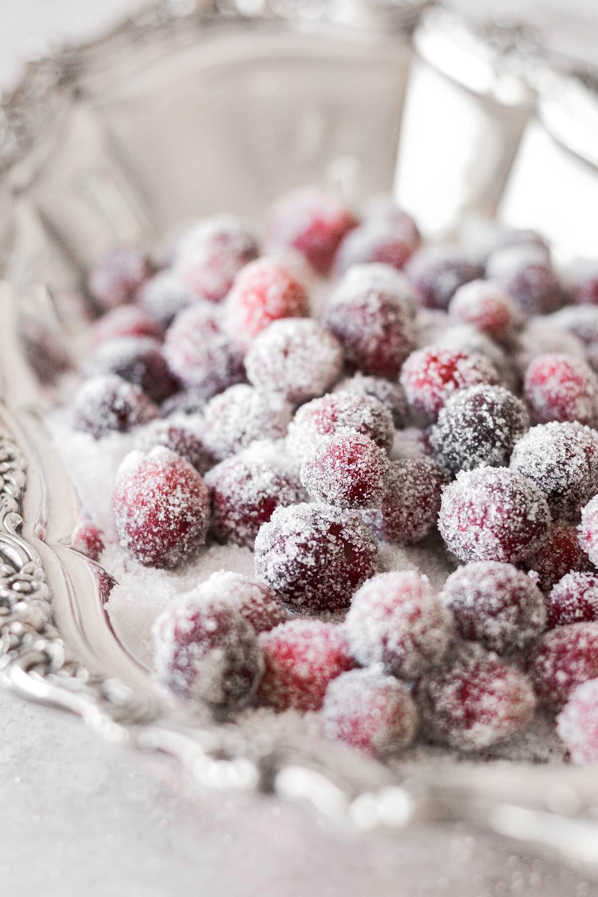 Sugared cranberries in a silver dish.