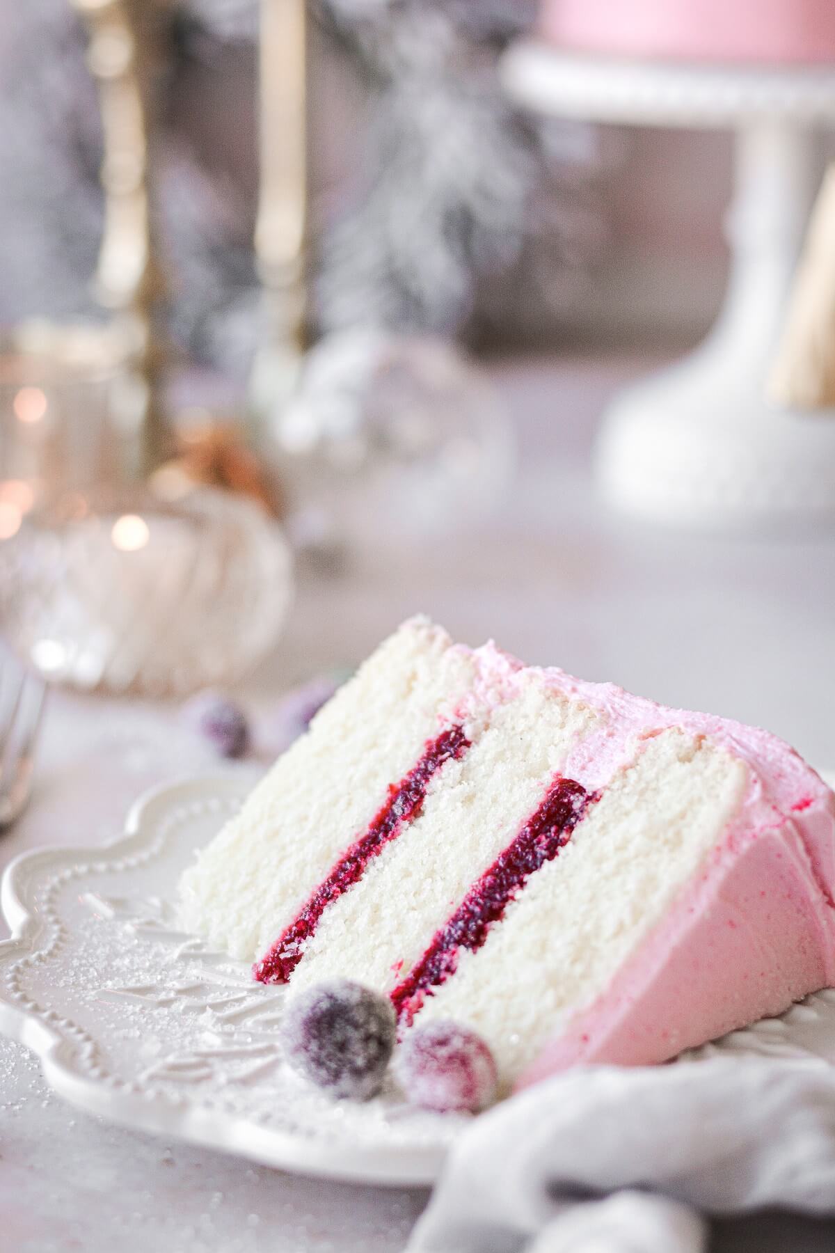 A slice of cranberry cake on a white plate.