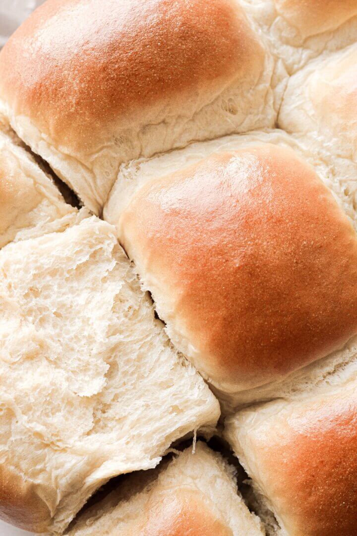 Closeup of just baked milk buns being pulled apart.