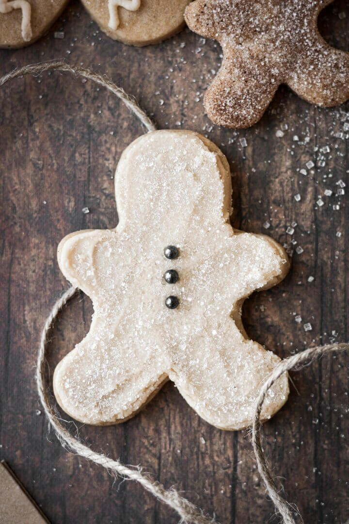 A gingerbread cookie with vanilla frosting and sparkling sugar.