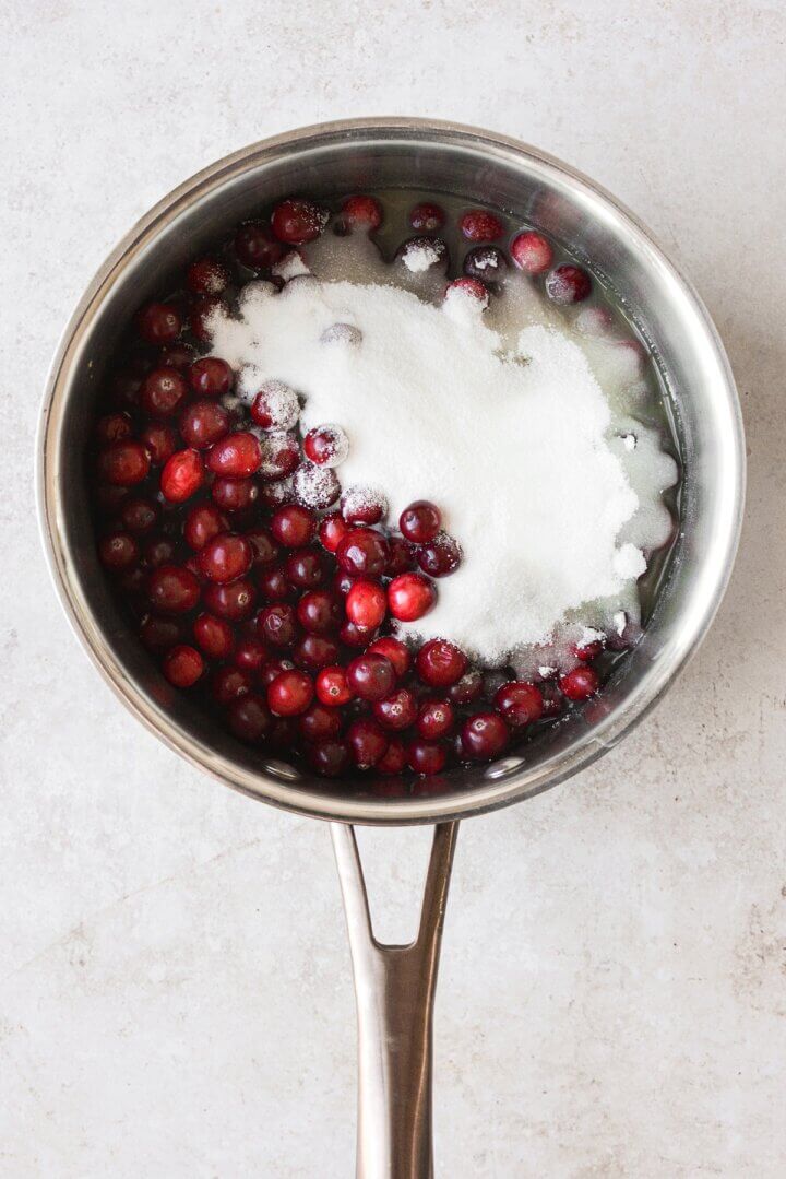 Cranberries and sugar in a saucepan.