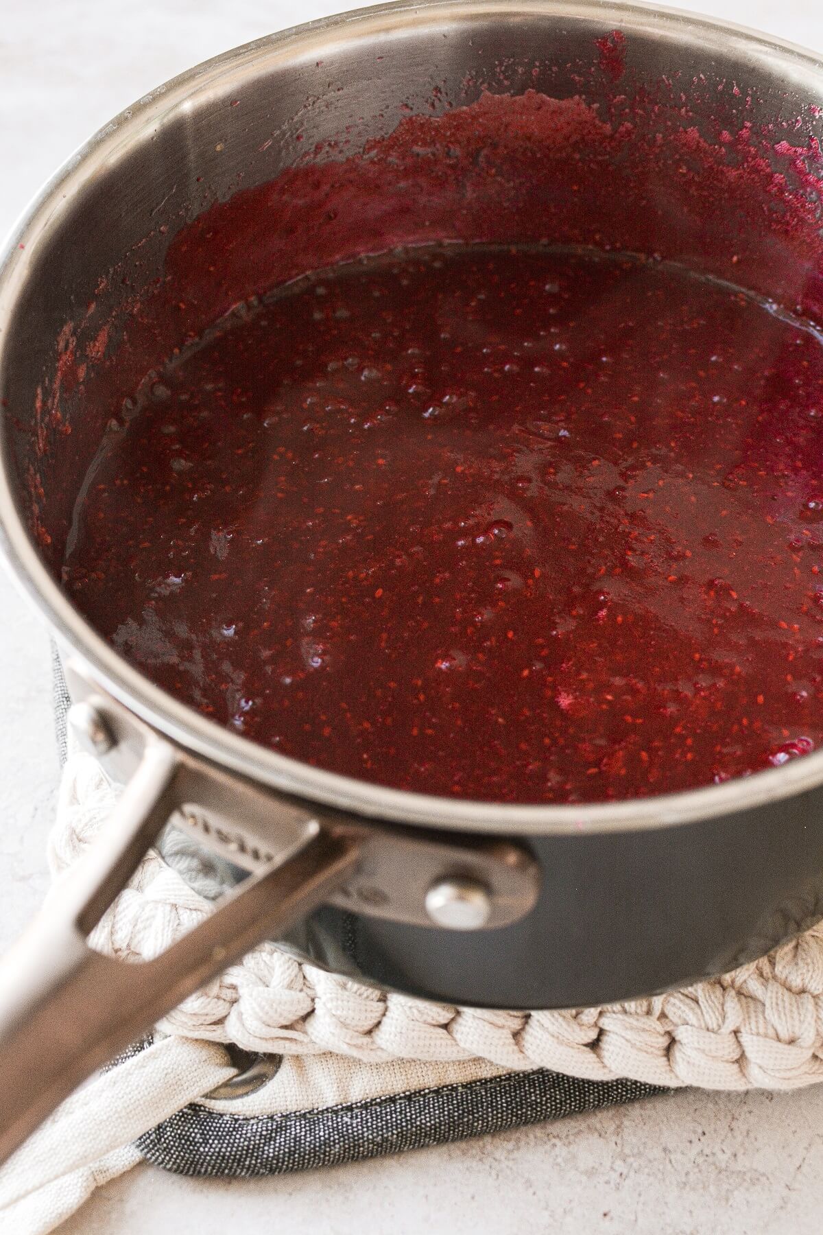 Homemade cranberry jelly, pureed in a saucepan.