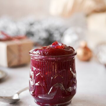 A glass jar filled with homemade cranberry jelly.