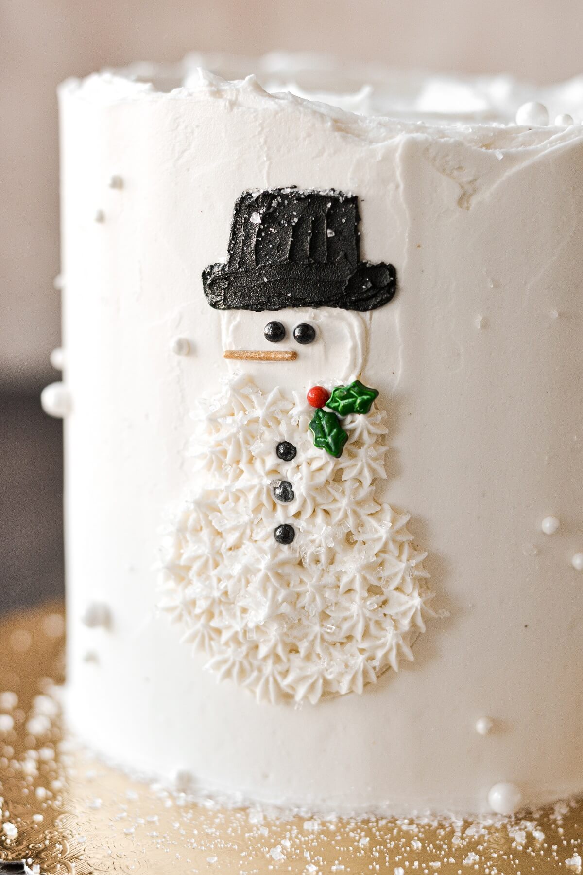 A Christmas cake with a buttercream snowman design.