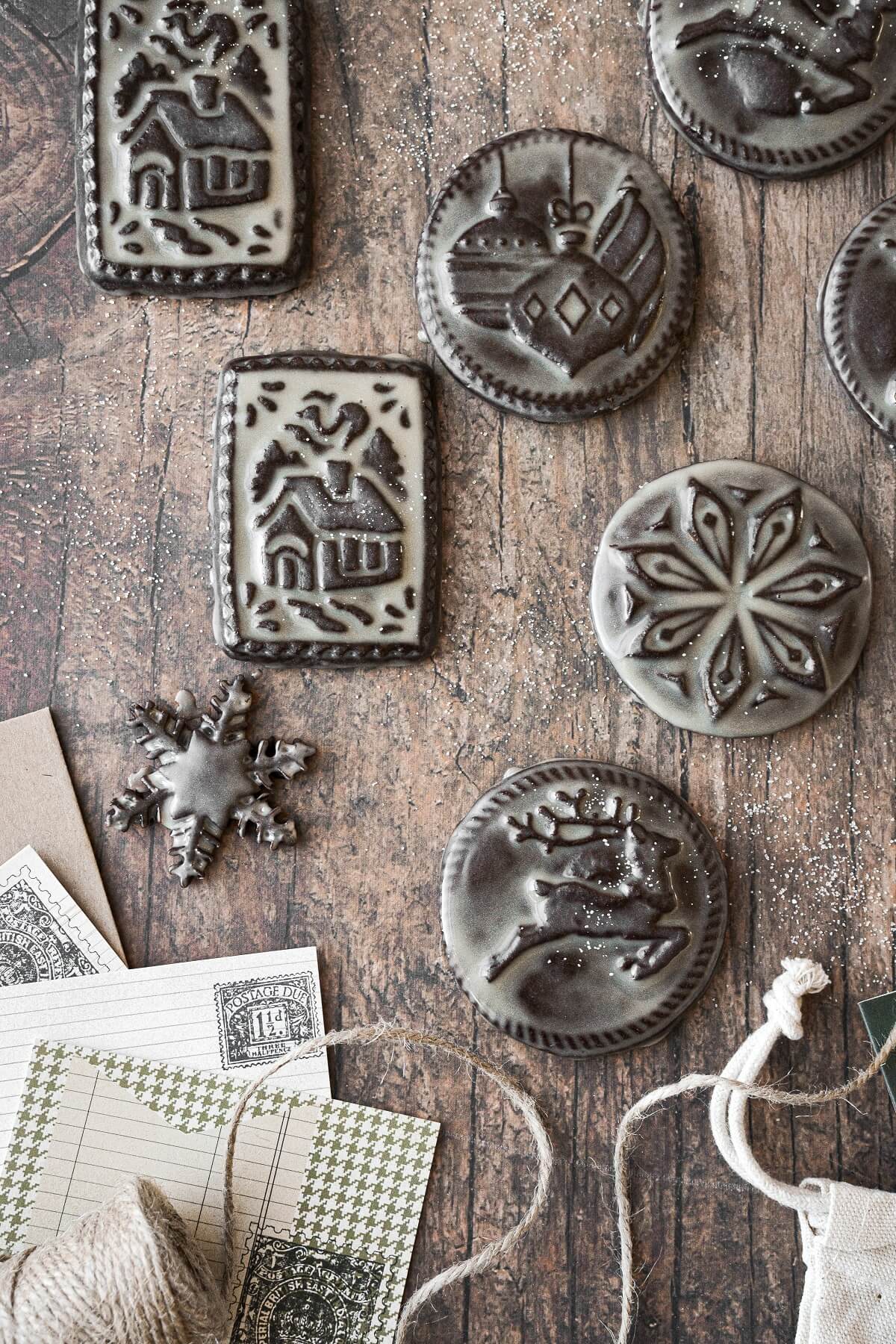 Chocolate shortbread cookies with Christmas designs stamped on them, glazed with icing.