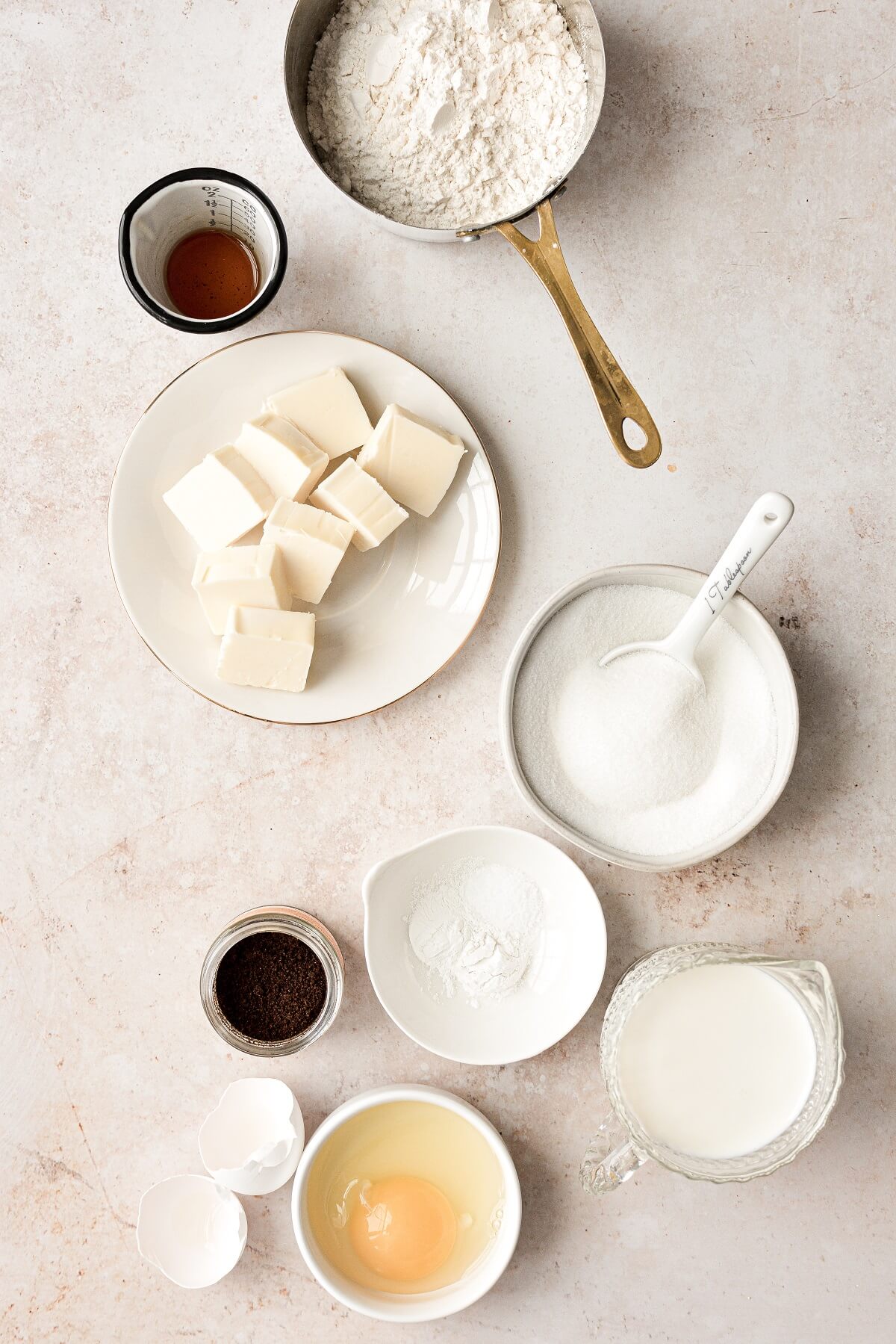 Ingredients for making baked vanilla cake doughnuts.
