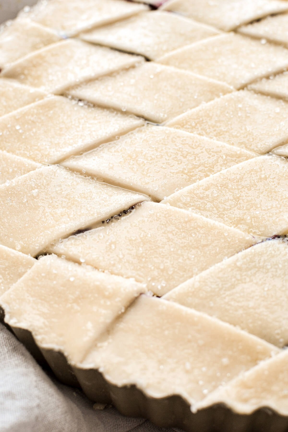 Closeup of lattice pie crust sprinkled with sugar.