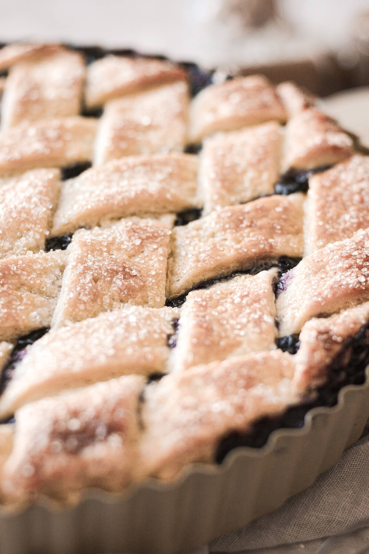 Closeup of lattice crust on a blueberry pie.