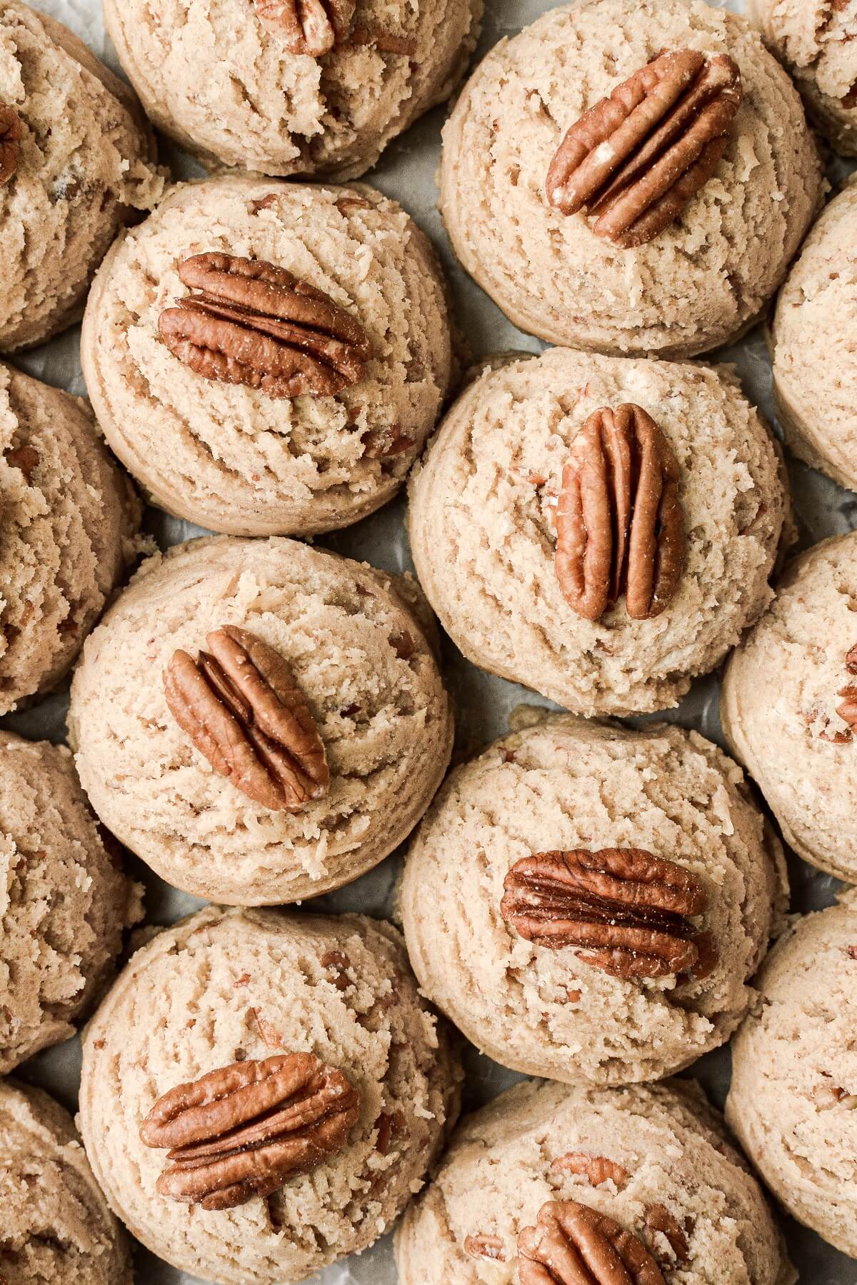 Pecans on top of cookie dough balls.