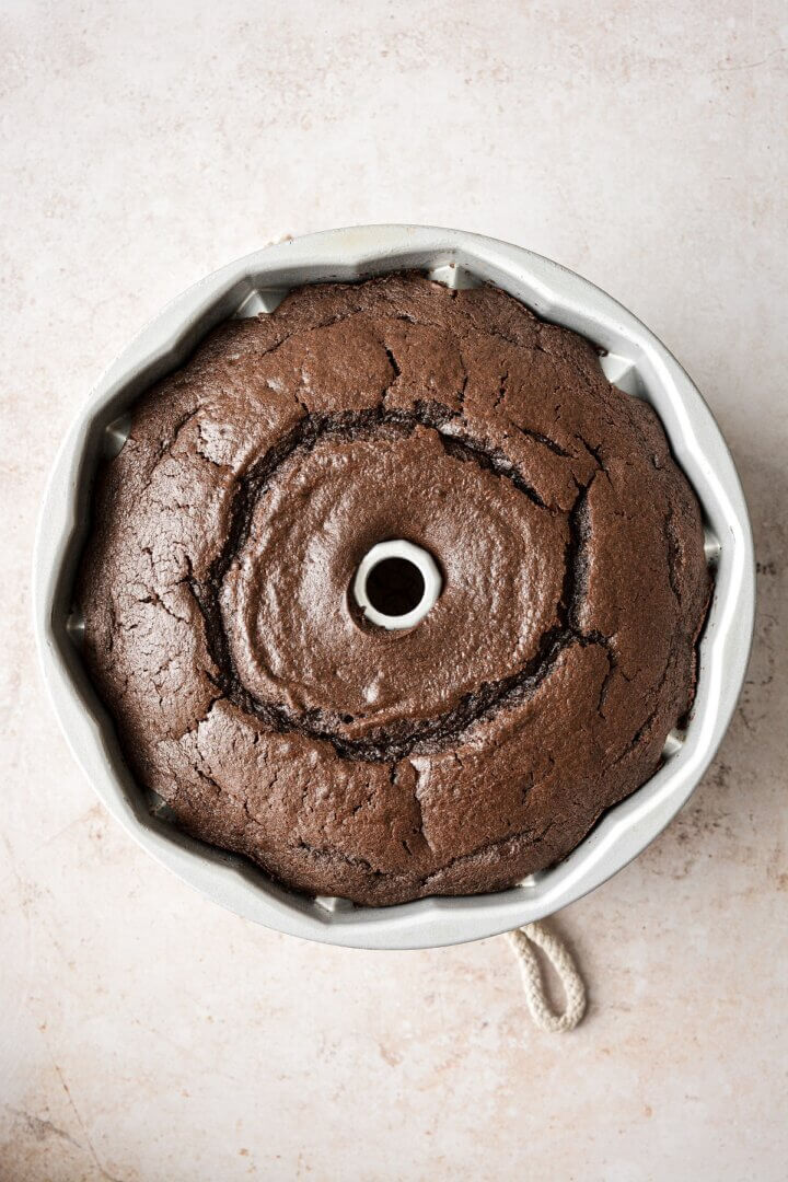 A just baked chocolate cake in a bundt pan.