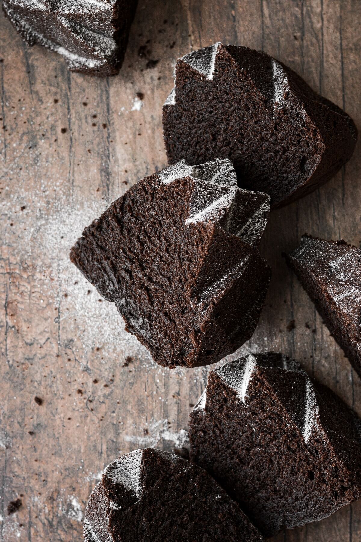 Slices of chocolate bundt cake dusted with powdered sugar.
