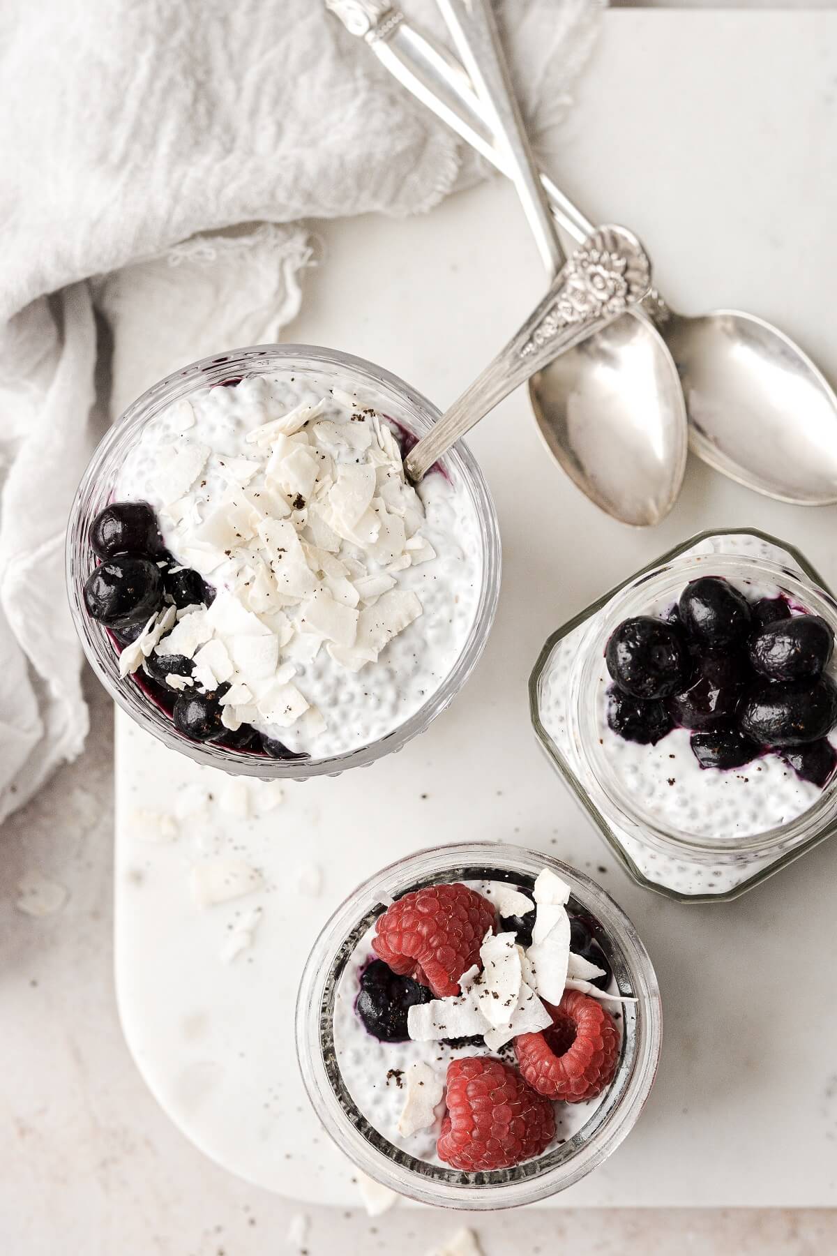 Coconut and berries on top of coconut chia pudding.