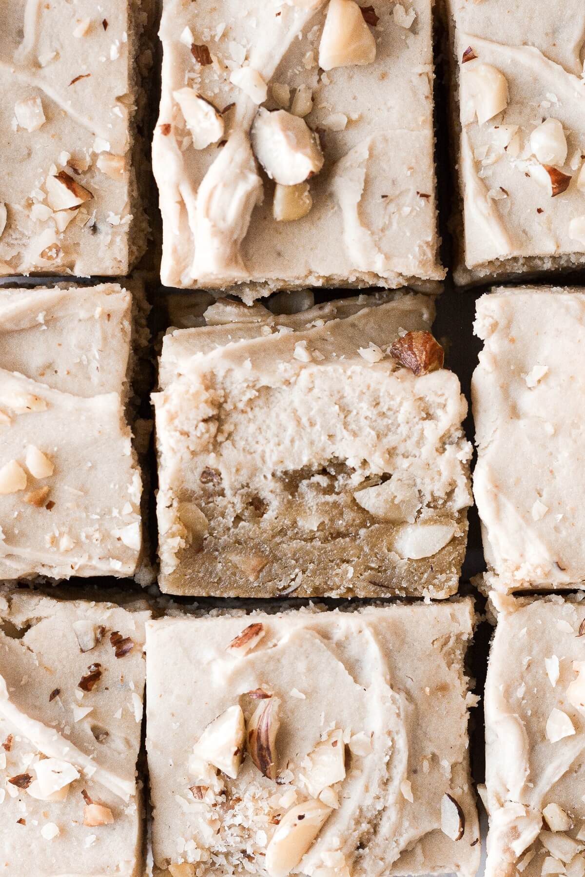 Closeup of frosted hazelnut maple sugar cookie bars.
