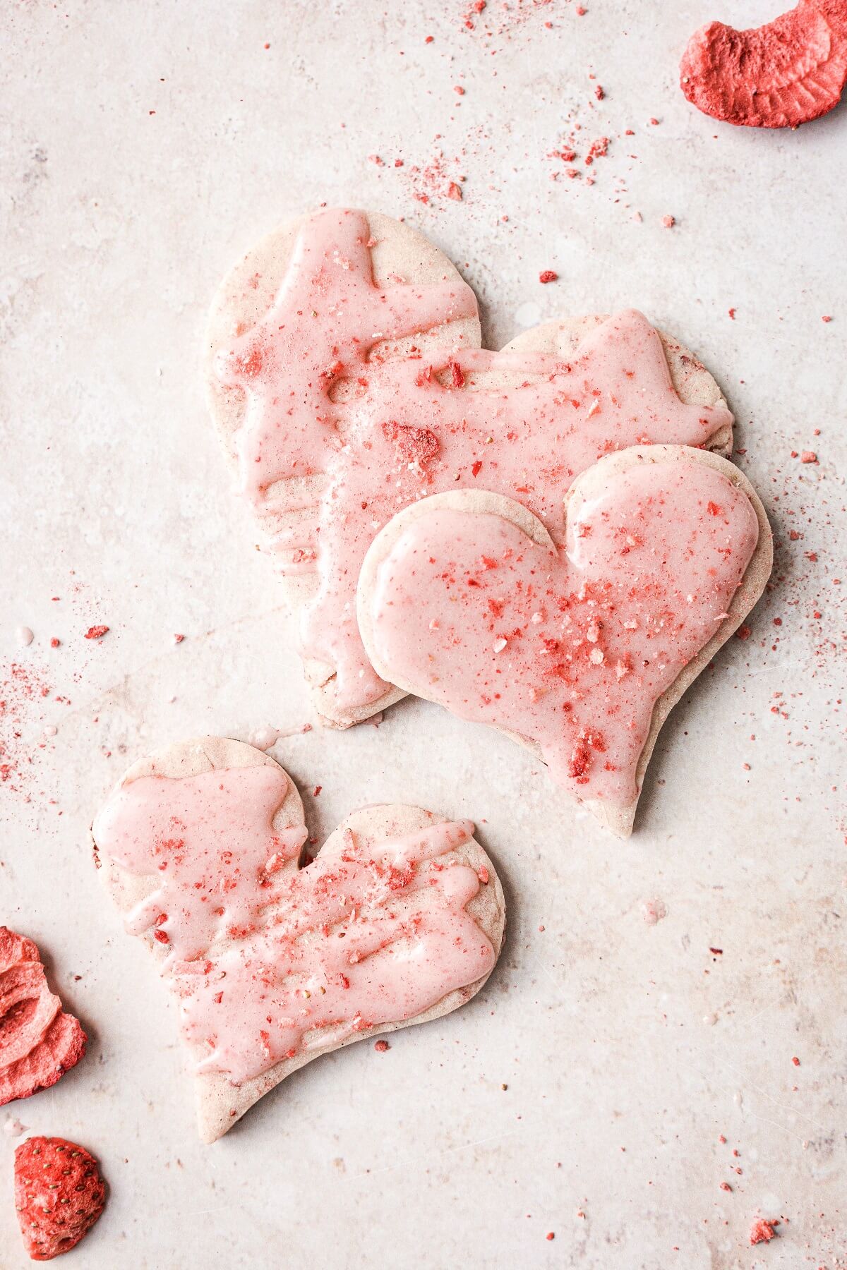 Heart shaped strawberry shortbread cookies with pink strawberry icing.