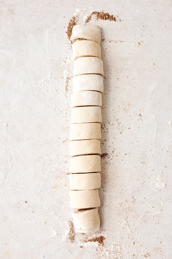 Cinnamon roll dough cut into rolls.
