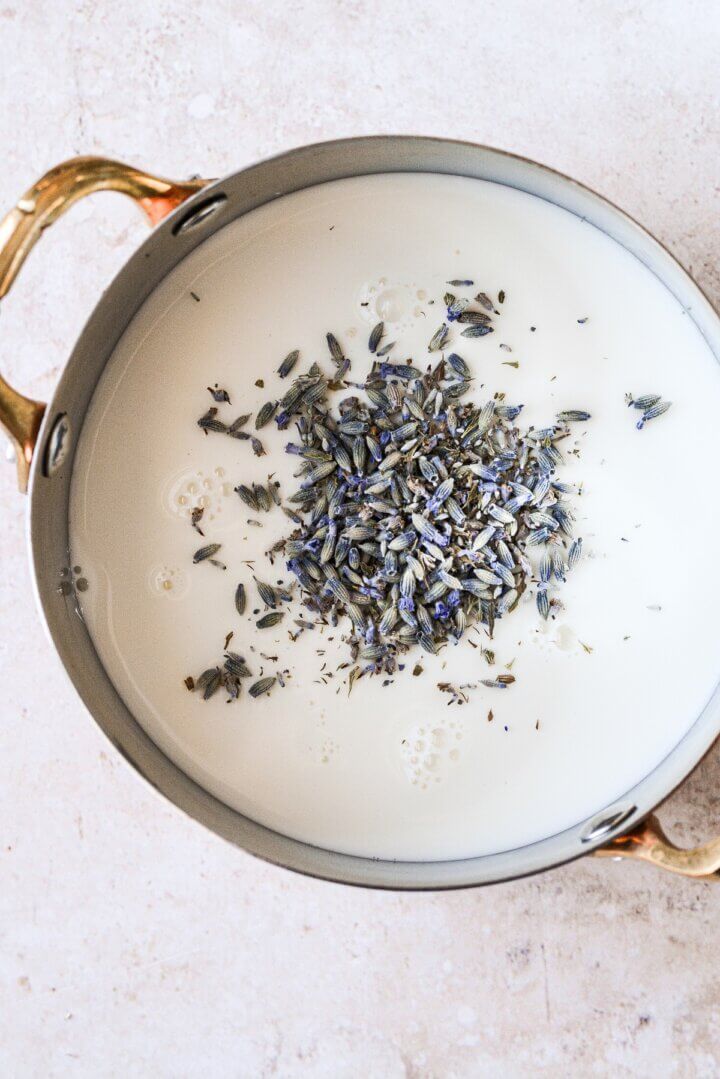 Lavender sprinkled over milk in a saucepan.