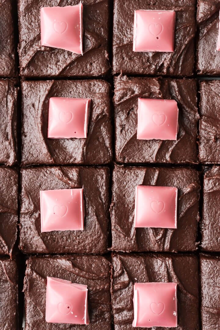 Valentines brownies cut into squares with chocolate buttercream and ruby chocolate.