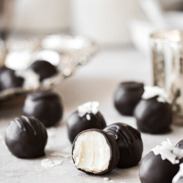 White chocolate coconut truffles dipped in dark chocolate and sprinkled with coconut.