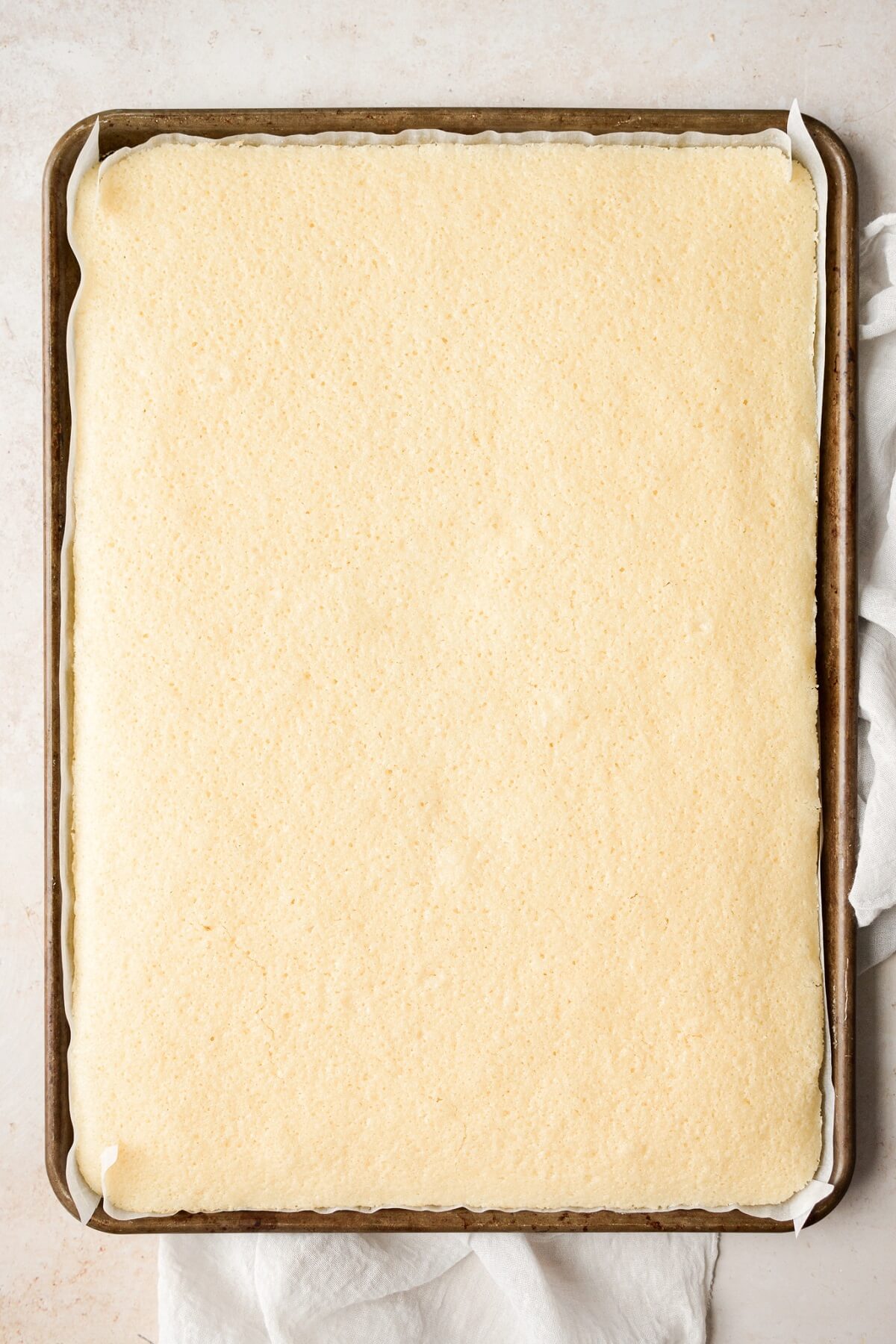 Vanilla cake baked in a sheet pan.