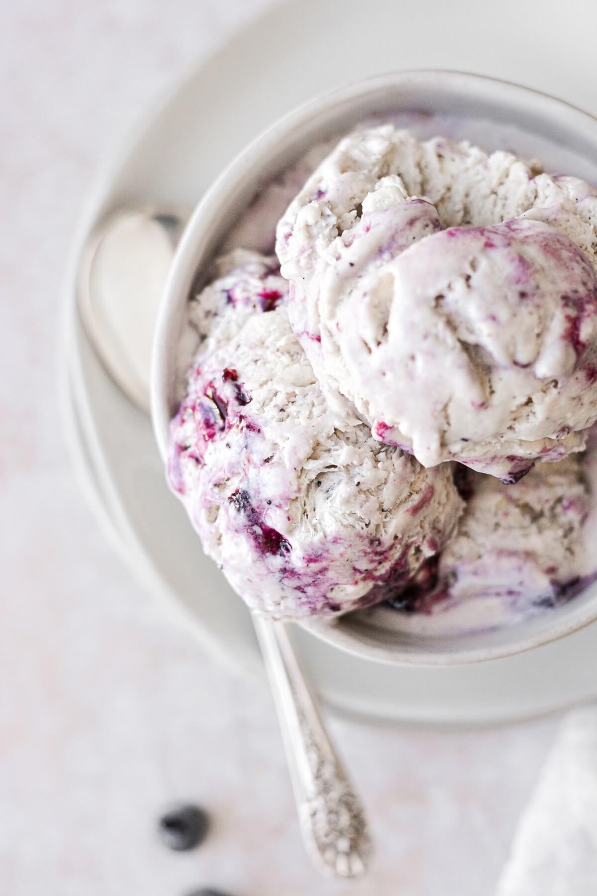 Bowl of no churn blueberry swirl ice cream.